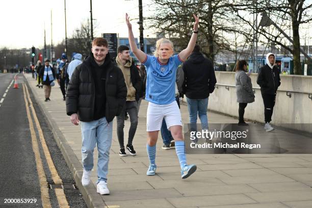 Manchester City fan wearing a mask of Erling Haaland leaves the stadium after the Premier League match between Manchester City and Everton FC at...