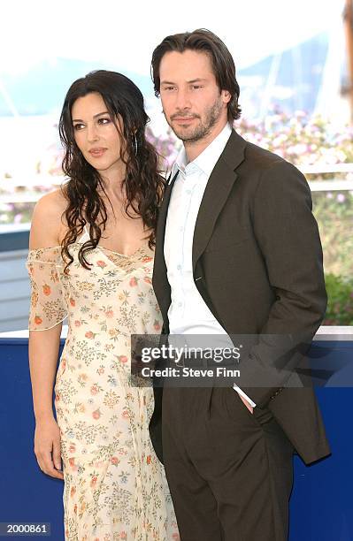 Actress Monica Bellucci and actor Keanu Reeves pose at a photocall for the film "The Matrix Reloaded" at the Palais des Festivals during the 56th...