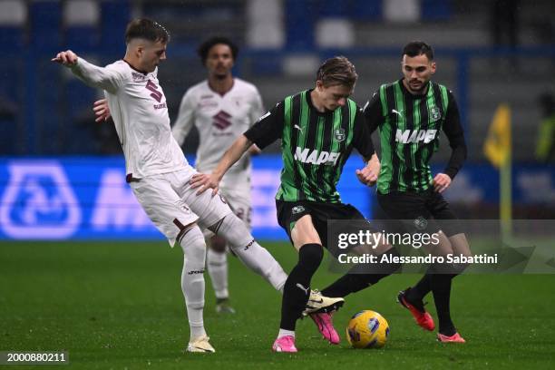 Ivan Ilić of Torino FC competes for the ball with Marcus Pedersen of US Sassuolo during the Serie A TIM match between US Sassuolo and Torino FC -...