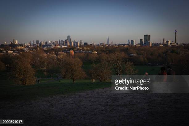 People are taking pictures of the London skyline from the top of Primrose Hill on January 26, 2024.