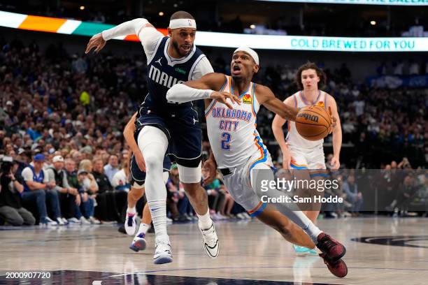 Shai Gilgeous-Alexander of the Oklahoma City Thunder is defended by Daniel Gafford of the Dallas Mavericks during the first half at American Airlines...