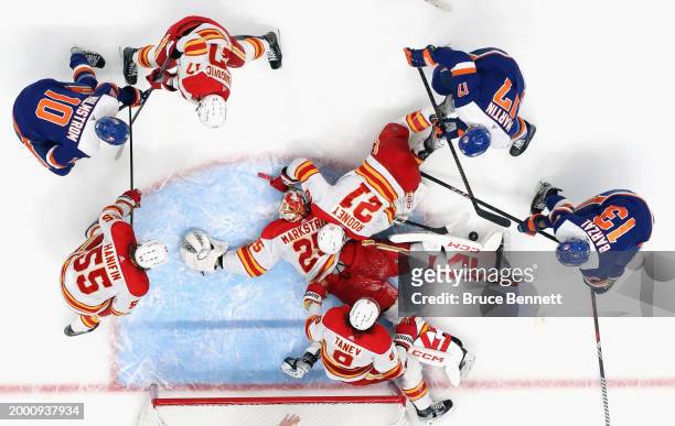 Jacob Markstrom and the Calgary Flames defend the net against the New York Islanders during the third period at UBS Arena on February 10, 2024 in...