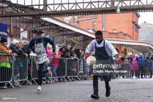 Competitors wearing fancy dress take part on Shrove Tuesday in the Windsor, Eton and Ascot Partnership Charity Pancake Race on 13th February 2024 in...