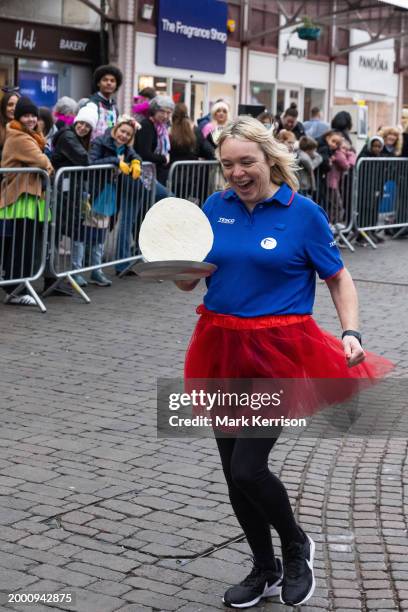 Competitor from a local business wearing fancy dress takes part on Shrove Tuesday in the Windsor, Eton and Ascot Partnership Charity Pancake Race on...