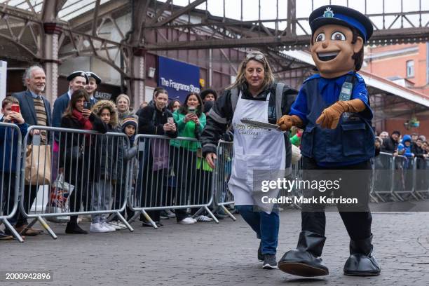 Mascot from the local police force takes part on Shrove Tuesday in the Windsor, Eton and Ascot Partnership Charity Pancake Race on 13th February 2024...
