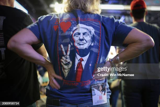 Supporters of Republican presidential candidate and former President Donald Trump listen while he speaks during a Get Out The Vote rally at Coastal...
