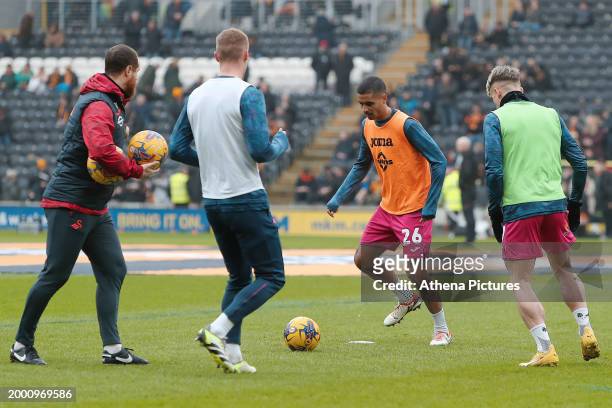 Ryan Harley, assistant head coach, Jay Fulton, Kyle Naughton andn Przemyslaw Placheta of Swansea City warm up prior to the game during the Sky Bet...