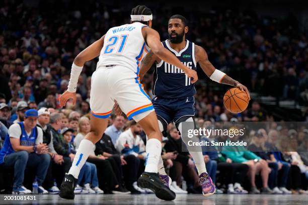 Kyrie Irving of the Dallas Mavericks is defended by Aaron Wiggins of the Oklahoma City Thunder during the second half at American Airlines Center on...