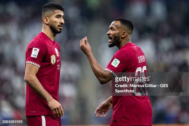 Ahmed Fathi of Qatar talks to Mohammed Waad of Qatar during the AFC Asian Cup final match between Jordan and Qatar at Lusail Stadium on February 10,...
