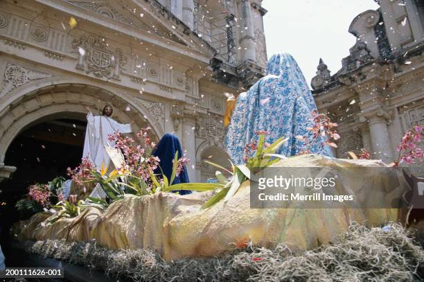 two women looking at jesus christ statue in front of church, rear view - festival float stock pictures, royalty-free photos & images
