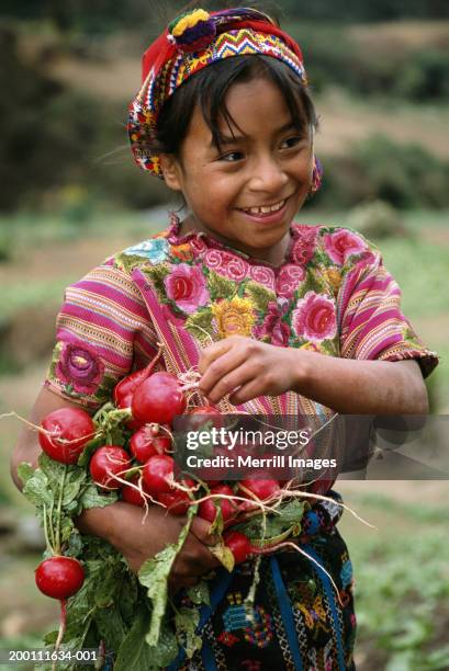 girl (8-10) picking radishes, smiling - guatemala bildbanksfoton och bilder