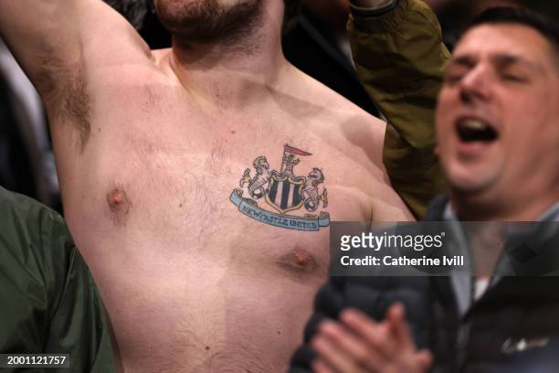 Fan of Newcastle United with the club badge tattooed on his chest during the Premier League match between Nottingham Forest and Newcastle United at...