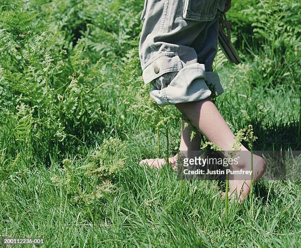 girl (7-9) walking on grass, low section - cargo pants heels stock pictures, royalty-free photos & images