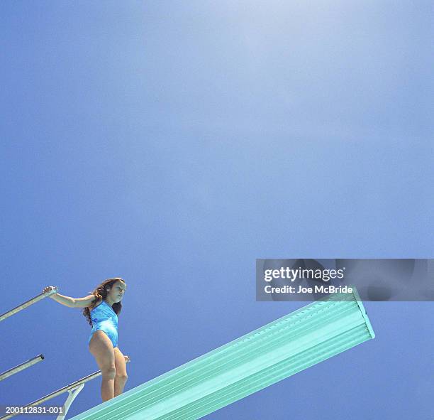 girl (8-10) standing on diving board, low angle view - kid looking down stock pictures, royalty-free photos & images