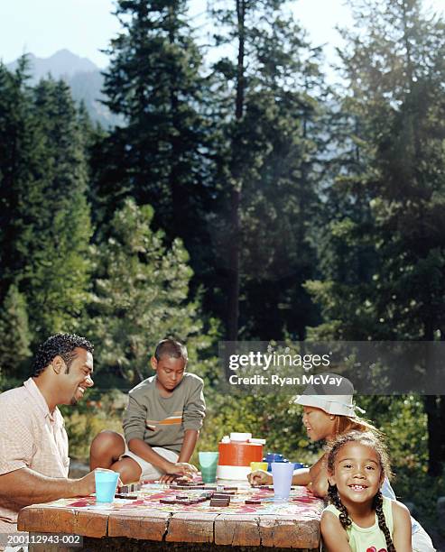 father and mother sitting with son and daughter (6-11) at picnic table - wenatchee stock pictures, royalty-free photos & images