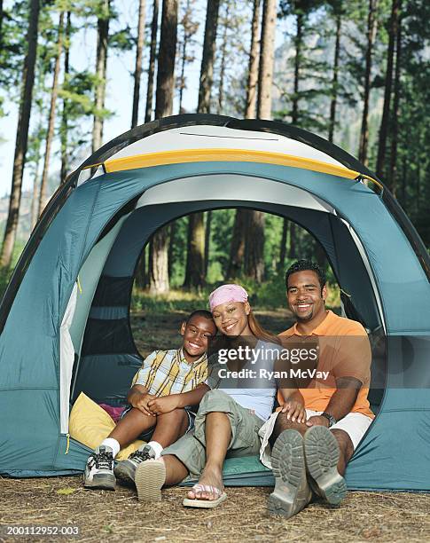 boy (10-12) sitting with parents in tent, portrait - open day 11 stock pictures, royalty-free photos & images
