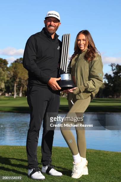 Captain Dustin Johnson of 4Aces GC poses with his wife Paulina Gretzky and the individual trophy after winning during day three of the LIV Golf...