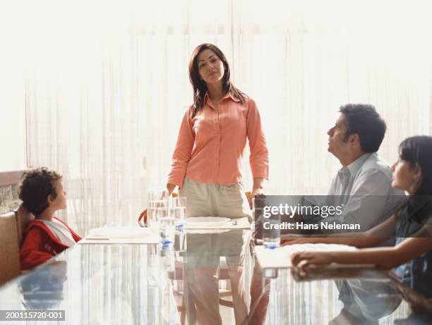 family at table, mother standing - perfect girls body stock pictures, royalty-free photos & images