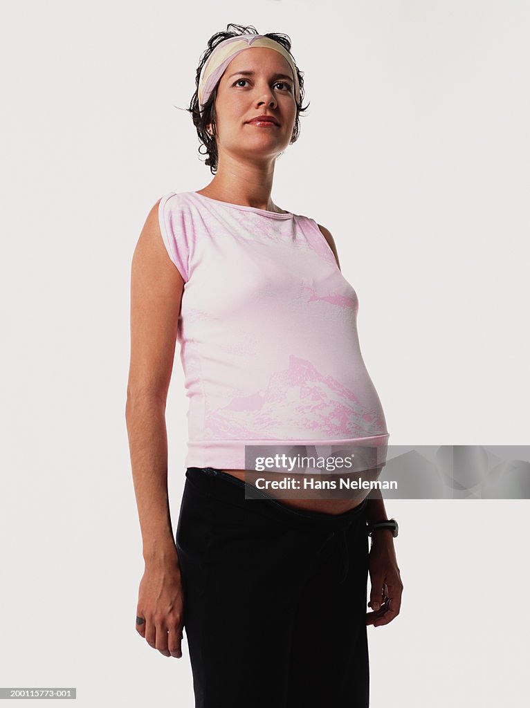 Pregnant woman in pink shirt and headband