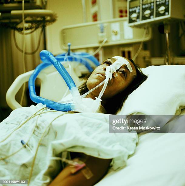 woman on respirator in intensive care unit (cross-processed) - hospital ventilator ストックフォトと画像