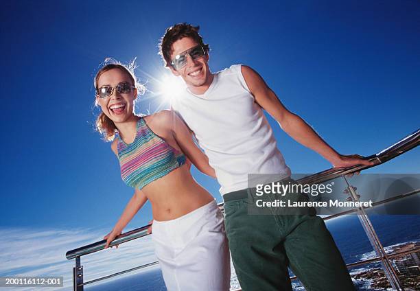 couple on balcony, laughing, portrait - sleeveless sweater stock pictures, royalty-free photos & images