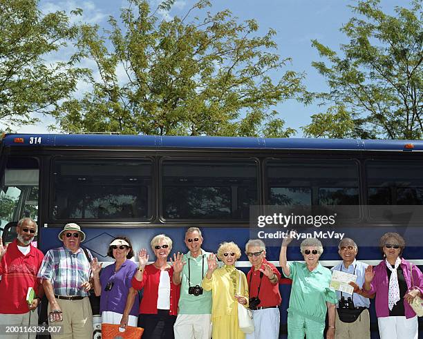 group of mature adults standing beside charter bus, smiling, portrait - coach bus 個照片及圖片檔