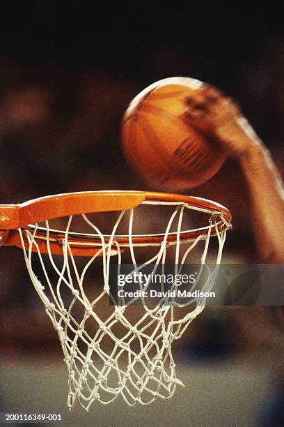 basketball player slam-dunking ball, close-up of hoop (blurred motion) - basketball close up ストックフォトと画像