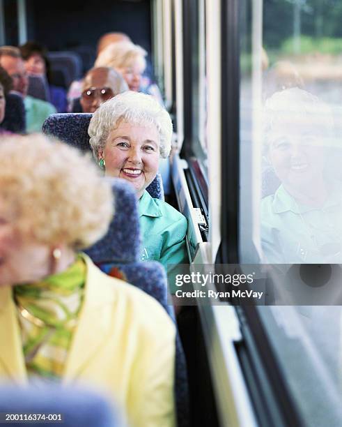 elderly woman on coach bus, smiling, portrait - car journey photos et images de collection