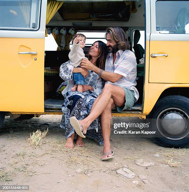 parents with baby girl (12-15 months) sitting in camper van doorway - yellow shoe stock pictures, royalty-free photos & images
