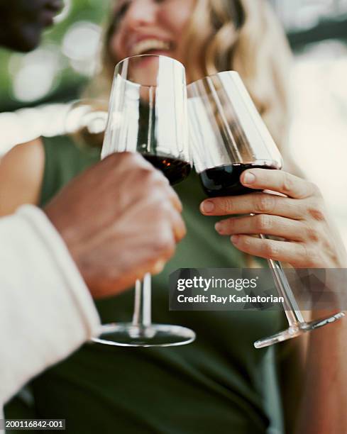 man and woman holding wine glasses, low angle view - low alcohol drink stock pictures, royalty-free photos & images