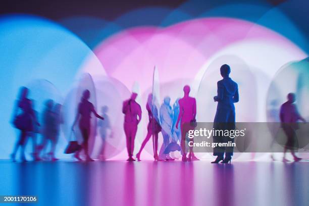 people silhouettes between abstract glass pieces - riflesso vetro foto e immagini stock