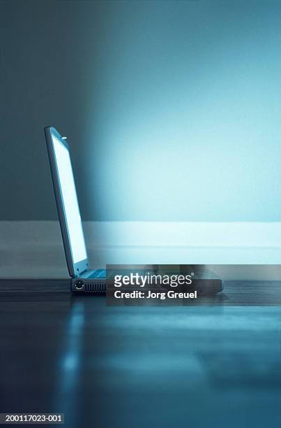 open laptop on floor, ground view - ominous computer stock pictures, royalty-free photos & images