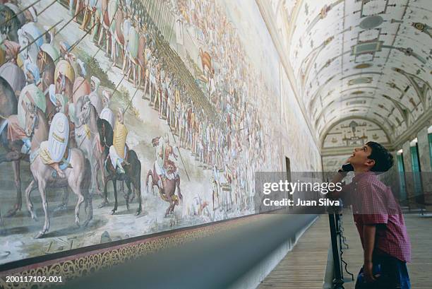 boy (10-12) looking at mural in escorial palace - child art fotografías e imágenes de stock
