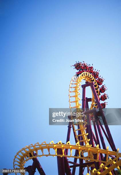people on roller coaster ride - achterbahn stock-fotos und bilder