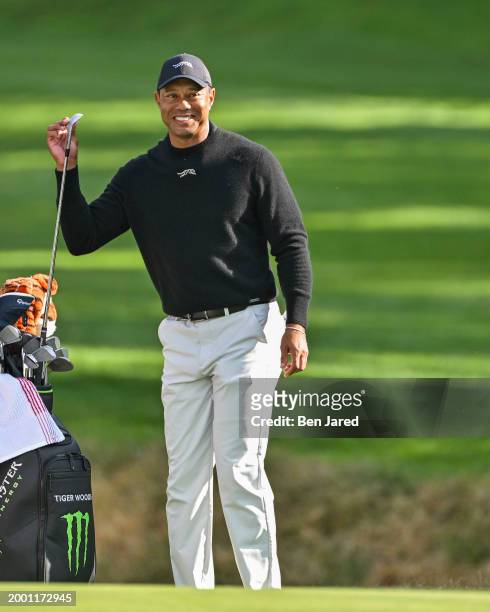Tiger Woods smiles with Jordan Spieth's caddie Michael Greller during practice for The Genesis Invitational at Riviera Country Club on February 13,...