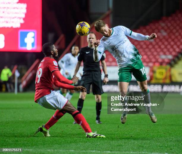 Lincoln City's Ted Bishop vies for possession with Charlton Athletic's Daniel Kanu during the Sky Bet League One match between Charlton Athletic and...