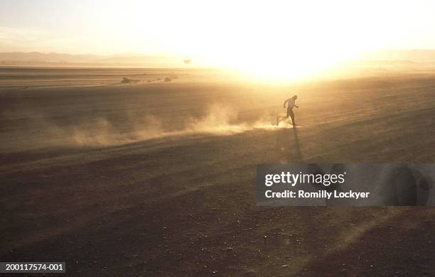 morocco, draa valley, man running through sandstorm - sandstorm stock pictures, royalty-free photos & images