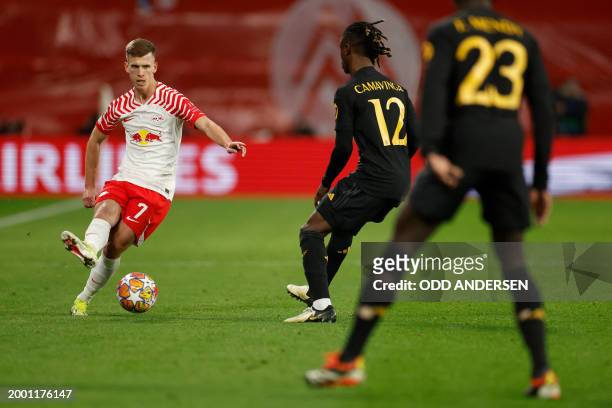 Leipzig's Spanish forward Dani Olmo plays the ball past Real Madrid's French midfielder Eduardo Camavinga Real Madrid's French defender Ferland Mendy...