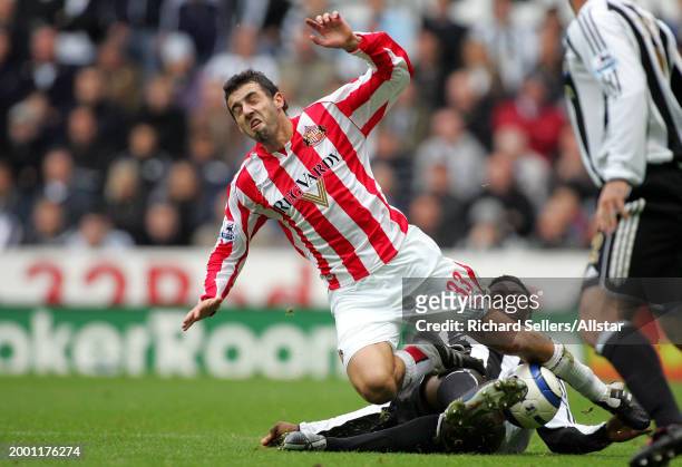 Julio Arca of Sunderland Is Tackled By Shola Ameobi of Newcastle United during the Premier League match between Newcastle United and Sunderland at St...
