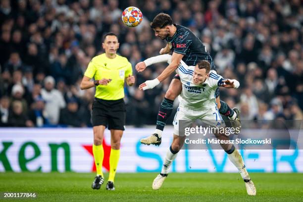 Ruben Dias of Manchester City and Viktor Claesson of F.C. Copenhagen battle for the ball during the UEFA Champions League 2023/24 round of 16 first...