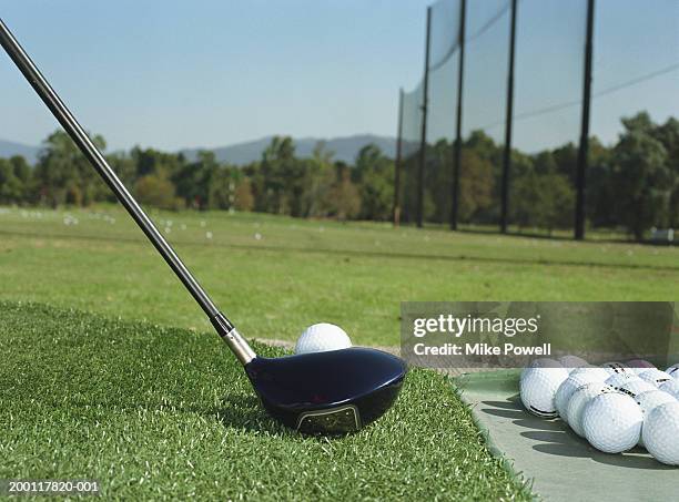 club lined up with golf ball on driving range (ground view) - driving range stock pictures, royalty-free photos & images