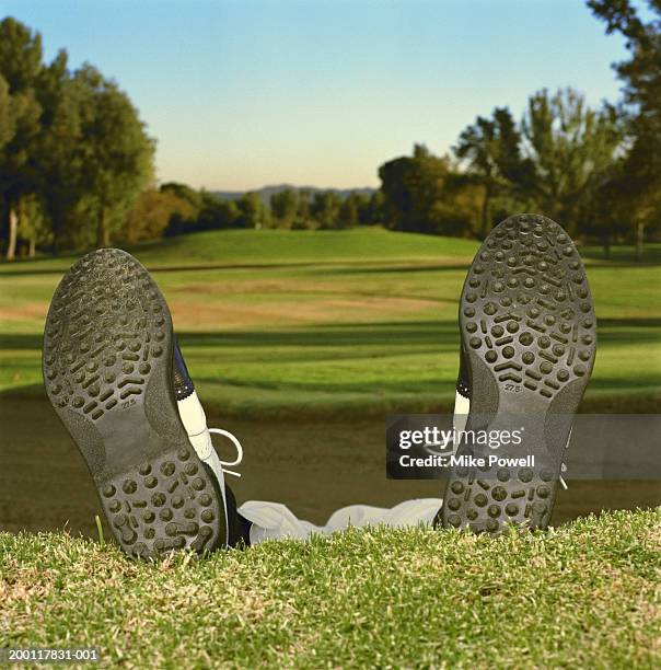 man lying in bunker on golf course, low section (ground view) - defeat funny stock pictures, royalty-free photos & images