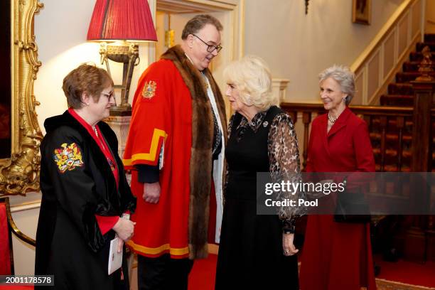 Queen Camilla, with Birgitte, Duchess of Gloucester, greets the Clerk of the Worshipful Company of Fan Makers, Mrs Claire Chitty, and the Master of...