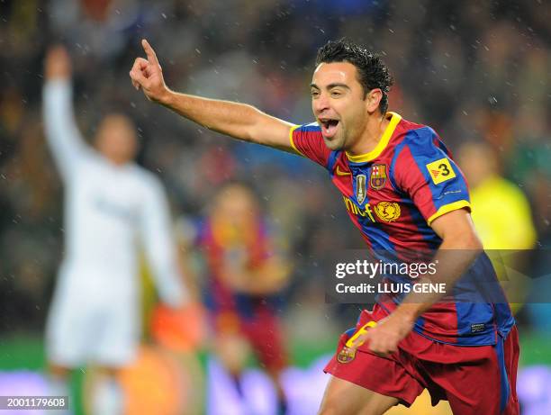 Barcelona's midfielder Xavi Hernandez celebrates after scoring against Real Madrid during the Spanish league "clasico" football match FC Barcelona vs...