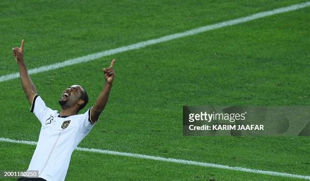 Germany's striker Cacau celebrates after scoring the fourth goal next to Australia's midfielder Carl Valeri during Group D first round 2010 World Cup...