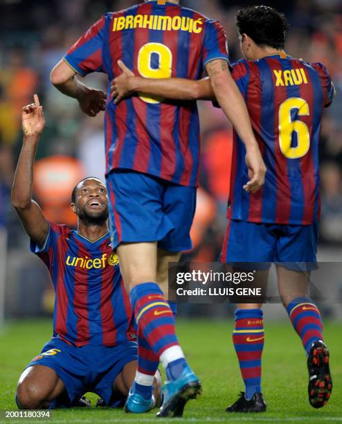 Barcelona's Malian midfielder Seydou Keita is congratulated by teammates Swedish forward Zlatan Ibrahimovic and midfielder Xavi Hernandez after...