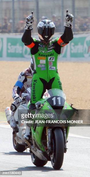 French pilot Gregory Leblanc jubilates on his Kawasaki after winning 33rd edition of the Le Mans 24-Hour endurance moto race on April 18, 2010 in Le...