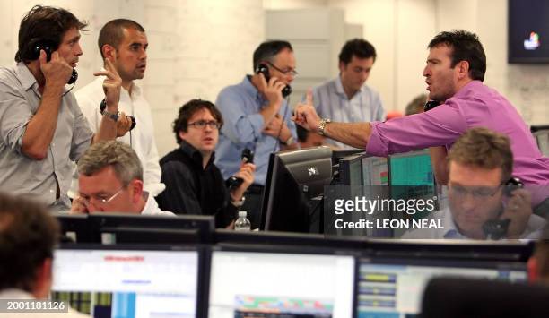 Brokers react to news of a 0,5 % cut in the interest rate from the The Bank of England, on ICAP's dealing floor, in London, on October 8, 2008. The...