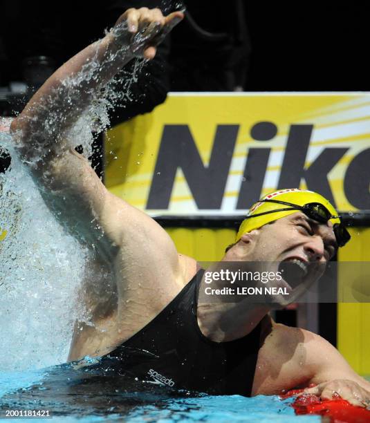 Austrian swimmer Markus Rogan celebrates after breaking the world record in the Mens 200m Backstroke Final during the fifth day of the ninth FINA...