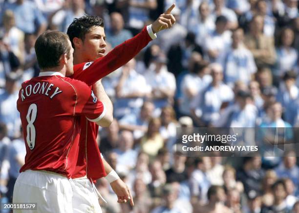 Manchester United's Portuguese striker Cristiano Ronaldo celebrates with midfielder team-mate Wayne Rooney after scoring from the penalty spot...
